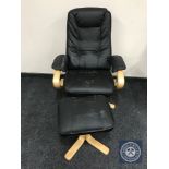 A pine framed black leather swivel relaxer chair with stool