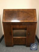 An early 20th century HMV radio turn table bureau, with integrated speaker and storage.