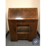 An early 20th century HMV radio turn table bureau, with integrated speaker and storage.