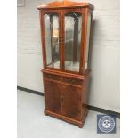 A yew wood display cabinet fitted double door cupboards and two drawers beneath CONDITION