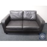 A black leather two seater settee