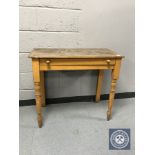 An antique pine side table fitted a drawer