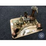 A tray containing assorted brass and copper ware including copper drinks measures,