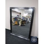 A black framed overmantel mirror