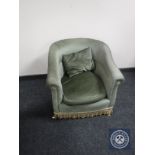 A twentieth century armchair upholstered in green dralon