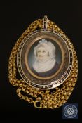 A fine quality Georgian gold memorial pendant, the rose-coloured frame with blue and white enamel,