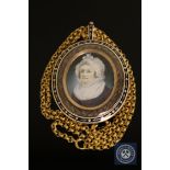 A fine quality Georgian gold memorial pendant, the rose-coloured frame with blue and white enamel,