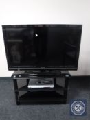 A Toshiba 40 inch LCD TV with remote on stand together with a Philips DVD player with remote