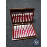 A mahogany canteen containing fish cutlery (12 settings)