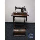 An oak cased vintage Singer hand sewing machine together with an oak barley twist occasional table