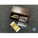 An oak box containing silver plated items including small photo frame, cigarette box etc,