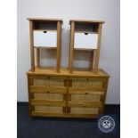 A pine and wicker six drawer chest and a pair of pine bedside cabinets