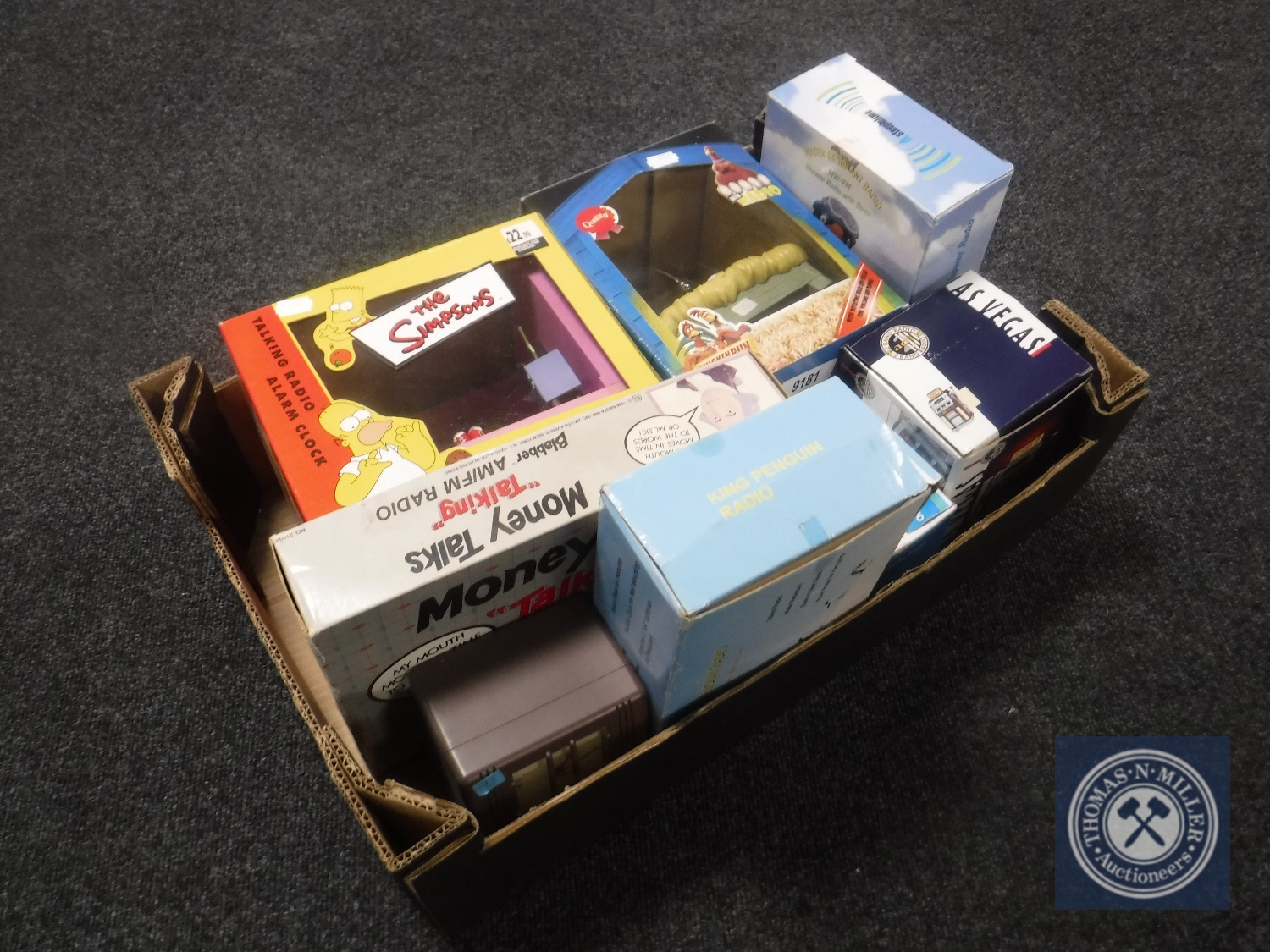 A box containing eight boxed novelty radios