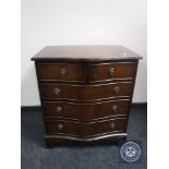 A mahogany serpentine fronted five drawer chest on bracket feet retailed by Chapmans