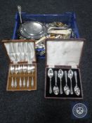 A basket containing assorted plated flatware, pewter scalloped-edge card tray,