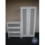 A white double door wardrobe and matching three drawer chest