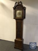 A Victorian carved oak longcase clock with brass and silvered dial