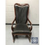 A Victorian mahogany scroll arm rocking chair