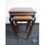 A nest of three mahogany tables on cabriole legs