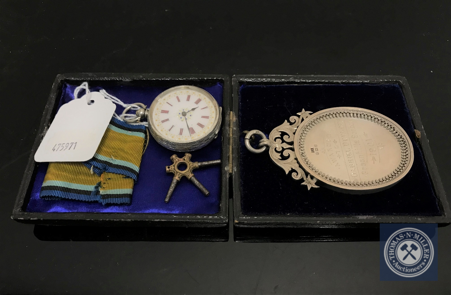 An early 20th century silver Dux medal together with a silver cased fob watch with key