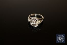 A 9ct white gold diamond cluster ring, the principal brilliant-cut stone weighing an estimated 0.