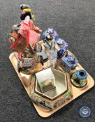 A tray containing oriental figurines and china to include Japanese candlestick,