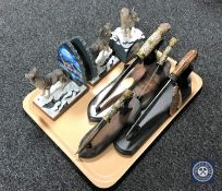 A tray containing four Native American style knives on stands,