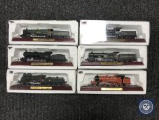 Six boxed die cast locomotives on wooden stands
