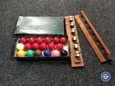 A two-piece snooker cue rack together with a set of snooker balls