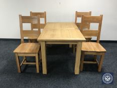 An oak kitchen table and four chairs