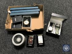 A box containing five Zippo lighters and six assorted wristwatches