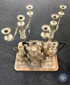 A tray of 20th century plated wares including a pair of three-way candelabra, three candle sticks,