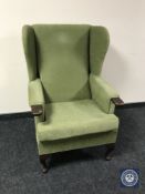 A mid 20th century wingback armchair