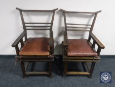 A pair of Chinese style armchairs with leather cushions