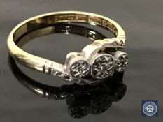 An 18ct gold and platinum three stone diamond ring