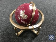 A gemstone globe on stand