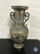 A 20th century brass Chinese twin handled embossed vase,