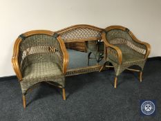 A wicker headboard and a pair of matching armchairs