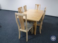 A contemporary beech extending dining table and six chairs