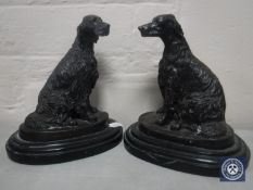 A pair of bronze figures of dogs on marble bases