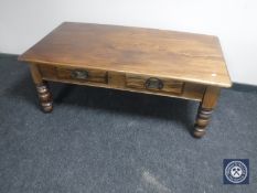 An Eastern mahogany coffee table fitted two drawers