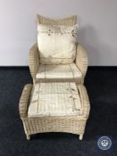 A wicker armchair with footstool