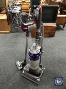 A Dyson DC 14 upright vacuum and a Dyson DC 35 hand hand vacuum plus a box of accessories