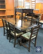 An Ercol refectory table with six rail back chairs and a mahogany occasional table