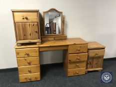 A pine knee hole dressing chest with mirror and a pair of bedside cabinets