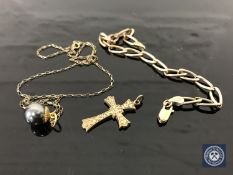 A 9ct gold bracelet, a crucifix and a pearl pendant 8.