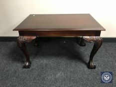 An Eastern mahogany coffee table on claw and ball feet