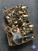 Two boxes containing brass chandeliers and wall lights,