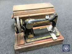 An oak cased vintage Singer hand sewing machine