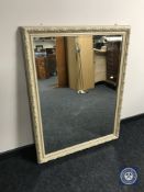A cream framed overmantel mirror